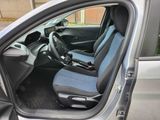 the interior of a car with a blue seat cover and a black steering wheel