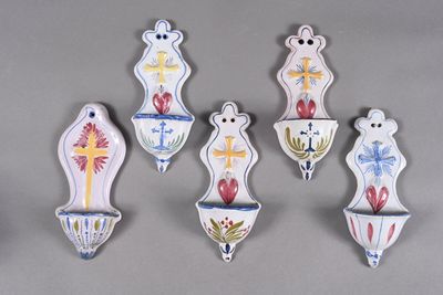 six ceramic wall hangings with crosses, crosses, and flowers
