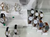 a lot of watches on display in a glass case