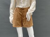 an image of a mannequin wearing a white blouse and brown shorts