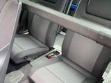 two seats in the back of a car with a remote control