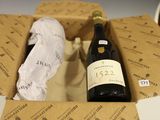 une bouteille de vin posée sur une table dans un coffret