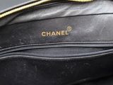 a close up of a black purse with a gold zipper