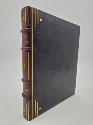 a black book with gold trims and a brown cover