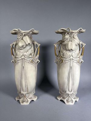 deux vases blancs posés l'un à côté de l'autre sur une table