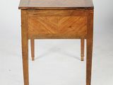 a small wooden table with a drawer on top of it