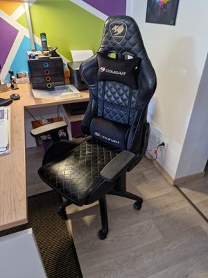 a desk with a chair and a computer on it