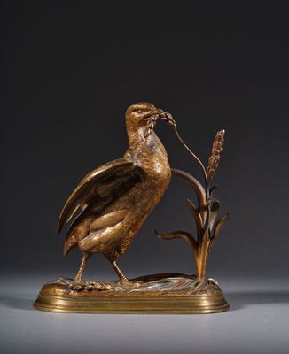 une sculpture en bronze représentant un oiseau perché sur une branche fleurie