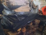 a pile of wood and a pile of firewood in a garage
