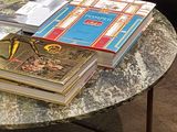 a coffee table with books on top of it in a living room