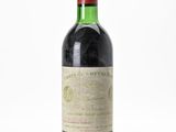 a close up of a bottle of wine on a white surface
