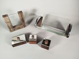 four different pieces of wood and glass on the table