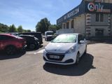 a white car parked in a parking lot in front of a building