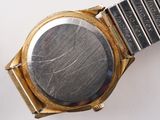 a close up of a watch on a white surface