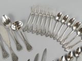 a lot of silver spoons and forks arranged in a circle