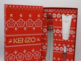 a close up of a red box with a bottle of kenzo on it
