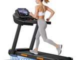 the woman is running on the tread machine with a laptop on it