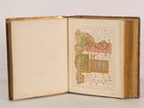 an open book with a picture of a tree and a bird on it