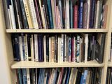 a bookshelf with many books on it in a room
