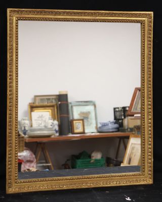 a mirror that is sitting on a shelf in a room
