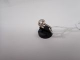 a close up of a diamond ring on a white surface