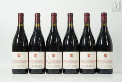 six bottles of red wine are lined up on a table