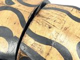 a close up of a piece of wood with a design on it