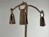 a metal pole with bells hanging from it ' s end