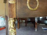 a wooden table with a gold decoration on it