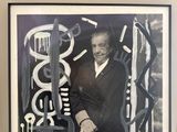 a picture of a man that is standing in front of a picture