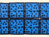 six blue and black polka dotty dice pieces on a white background