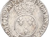 a silver coin with a crown on top of it