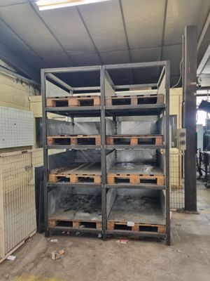 a room with a lot of shelves and a lot of bins