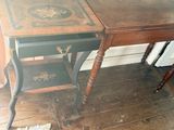a small table with a drawer on it in a room