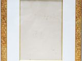 a gold and white picture frame on a white background