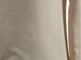 the back of a woman ' s white shirt with a black belt