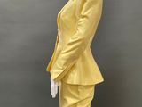 an image of a mannequin wearing a yellow suit and skirt