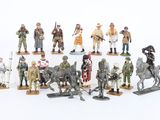 a lot of figurines of soldiers on a white surface