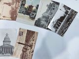 many old postcards on a table with a building in the background