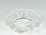 a clear glass bowl with flowers on it on a white surface