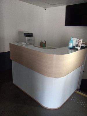 une photo d'un comptoir d'accueil avec une télévision accrochée au mur