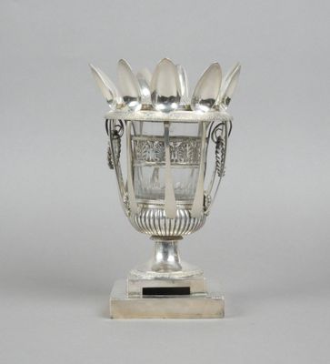 a silver cup with spoons and spoon spoons in it