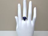 a hand with a ring on it that is sitting on a mannequin