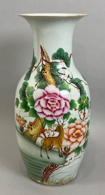 a vase with a bird and flowers painted on it