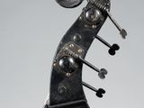 a close up of the back of a violin with the strings still attached