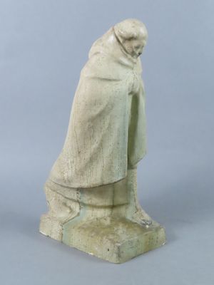 statue of a man in a cloak and cloak standing on a stone base
