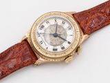 an image of a gold wrist watch with a brown leather strap