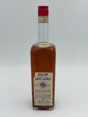 a close up of a bottle of rum on a white surface