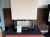 a stove that is sitting in the middle of a room