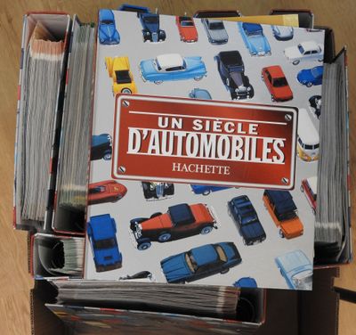 a stack of books on a table with cars on it